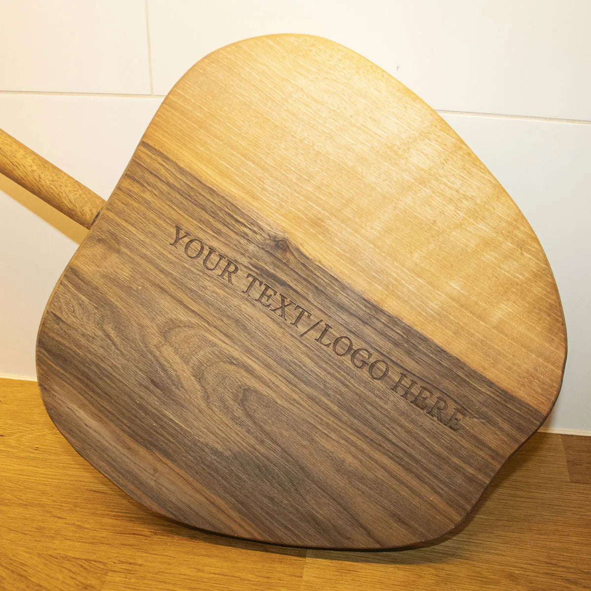 Side view showing thickness and craftsmanship of apple-shaped walnut cutting board