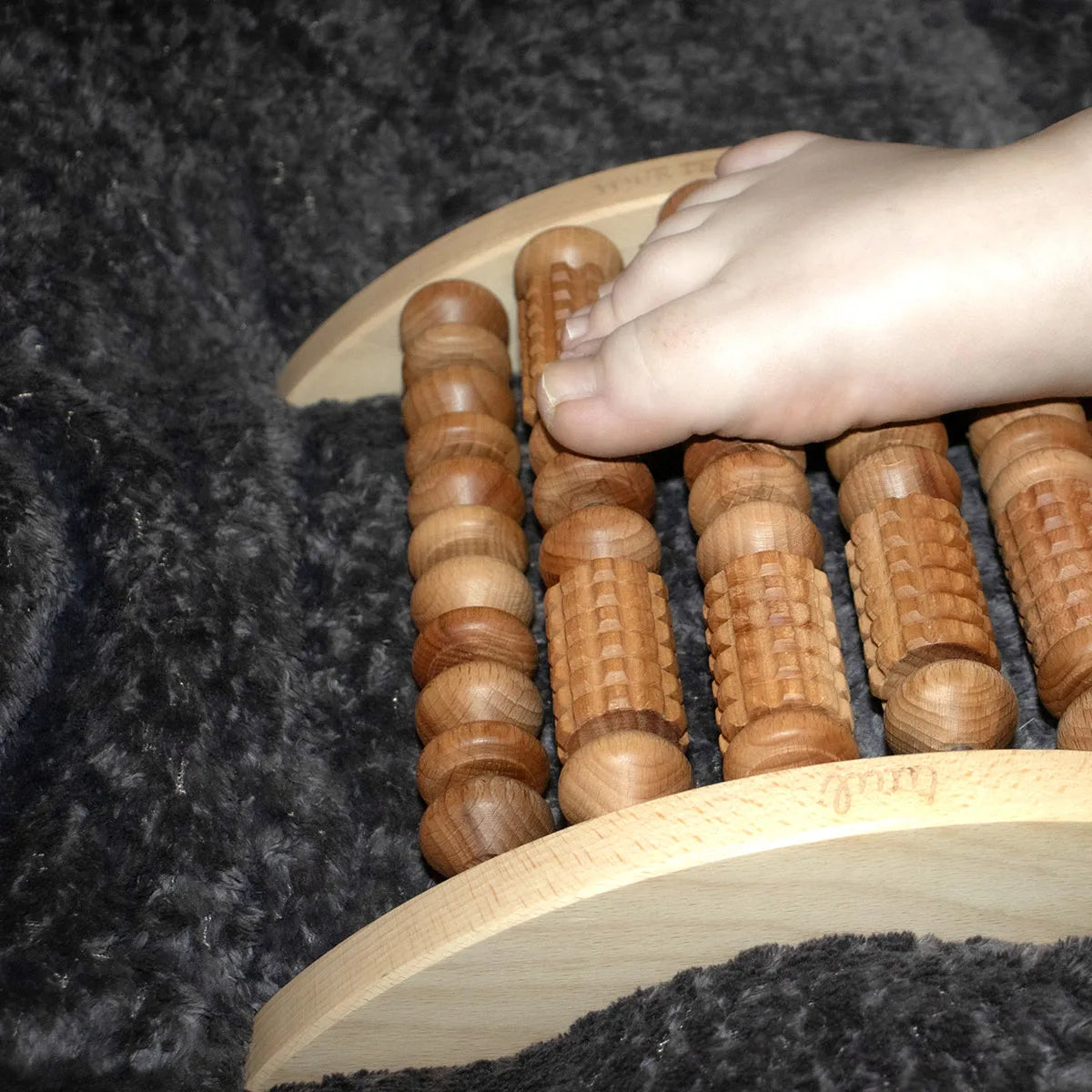 Wellness Professional Explaining Custom Features of Premium Wooden Foot Massage Tool