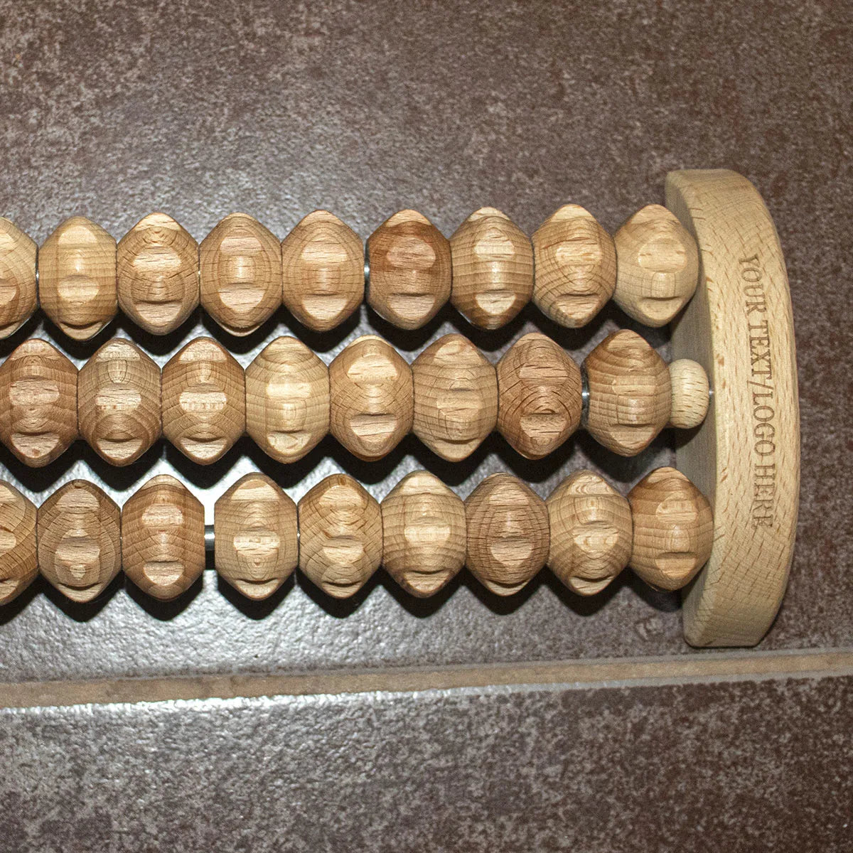 Sustainable beech wood foot massage tool with natural grain texture