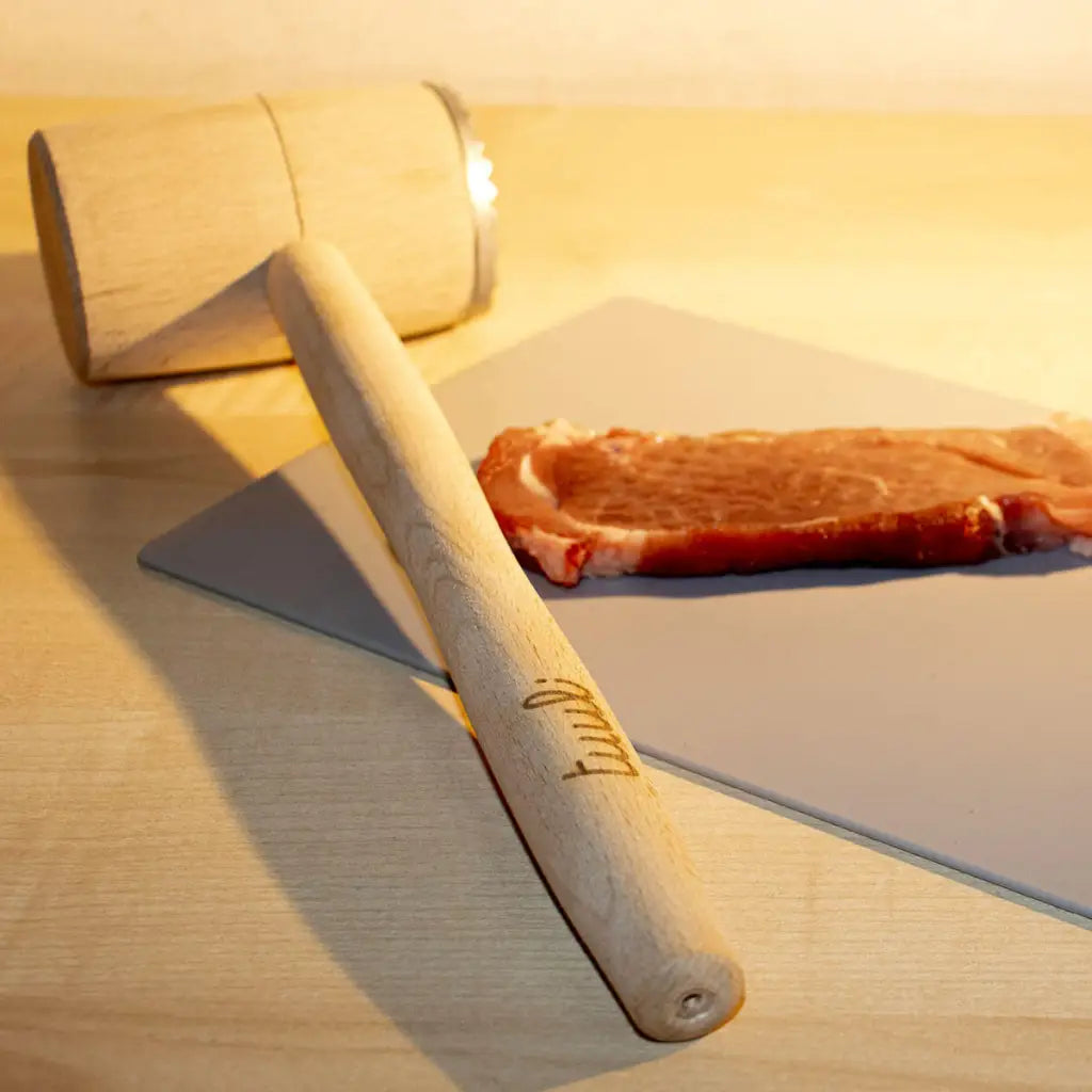 Close-up of personalized engraving detail on wooden meat tenderizer handle