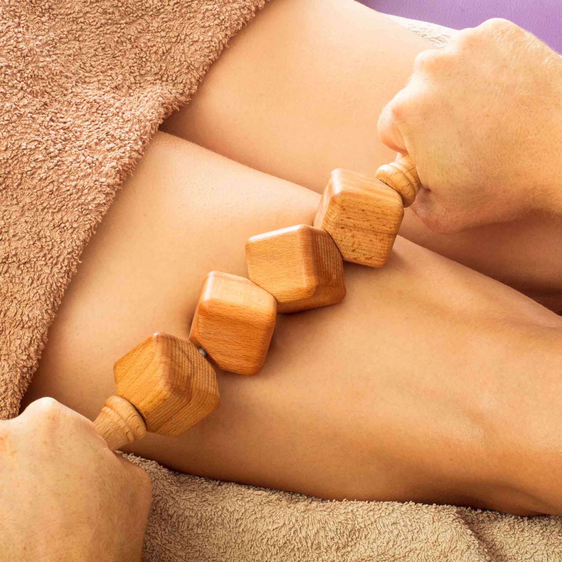 40 cm beechwood dice massage roller with easy-grip handle on neutral background